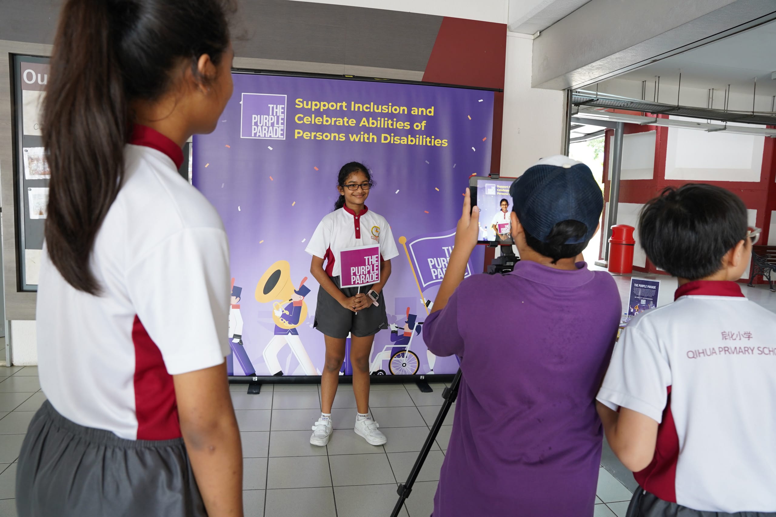 An indian girls took photo with purple parade banner